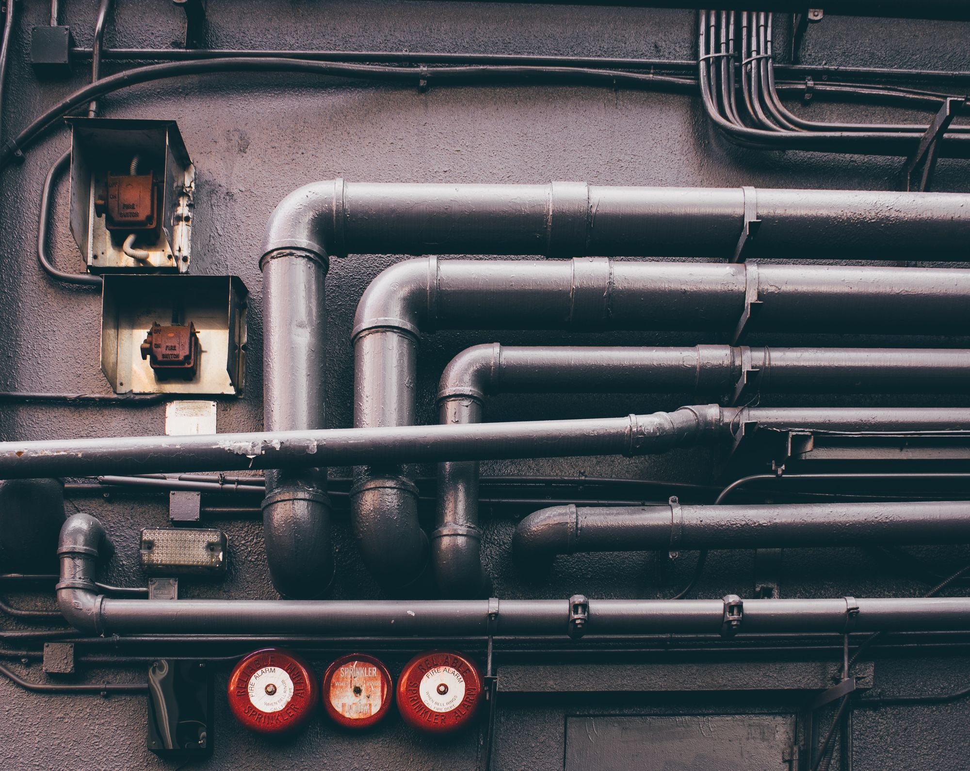 Pipes and sockets on a grey wall