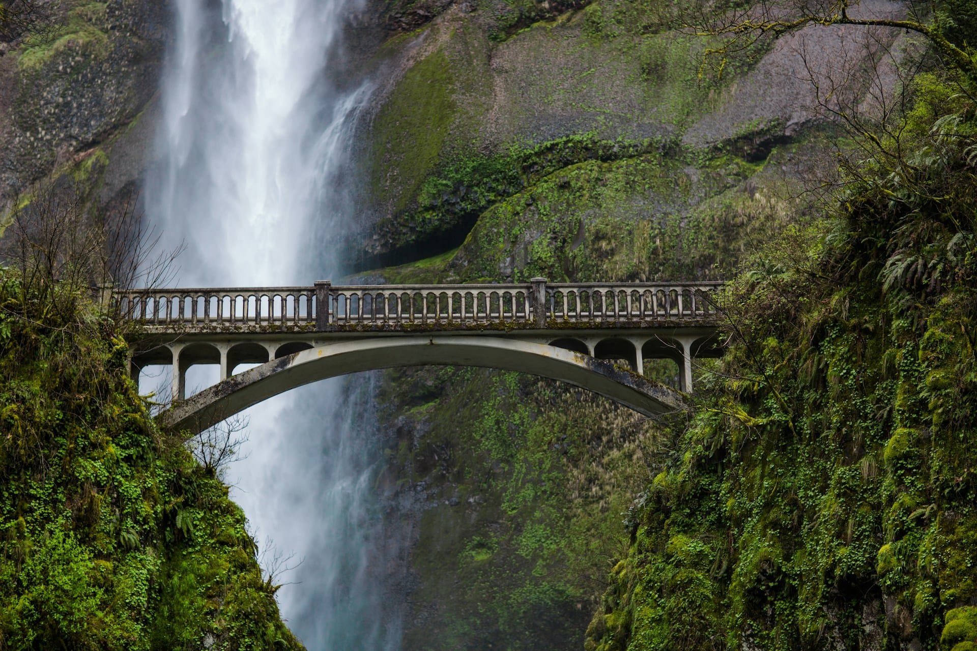A bridge with a waterfall in the background
